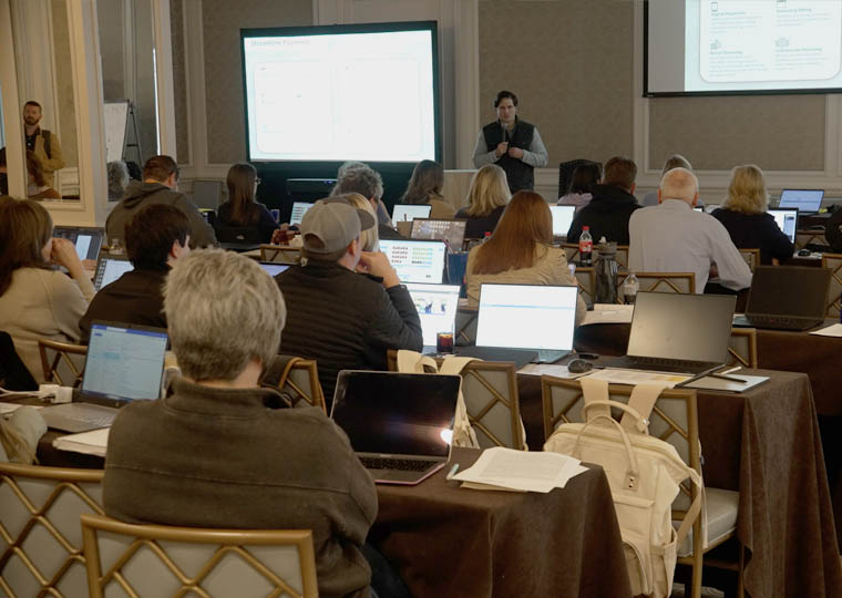 A class of professional  employees as students looking at the front of the class
