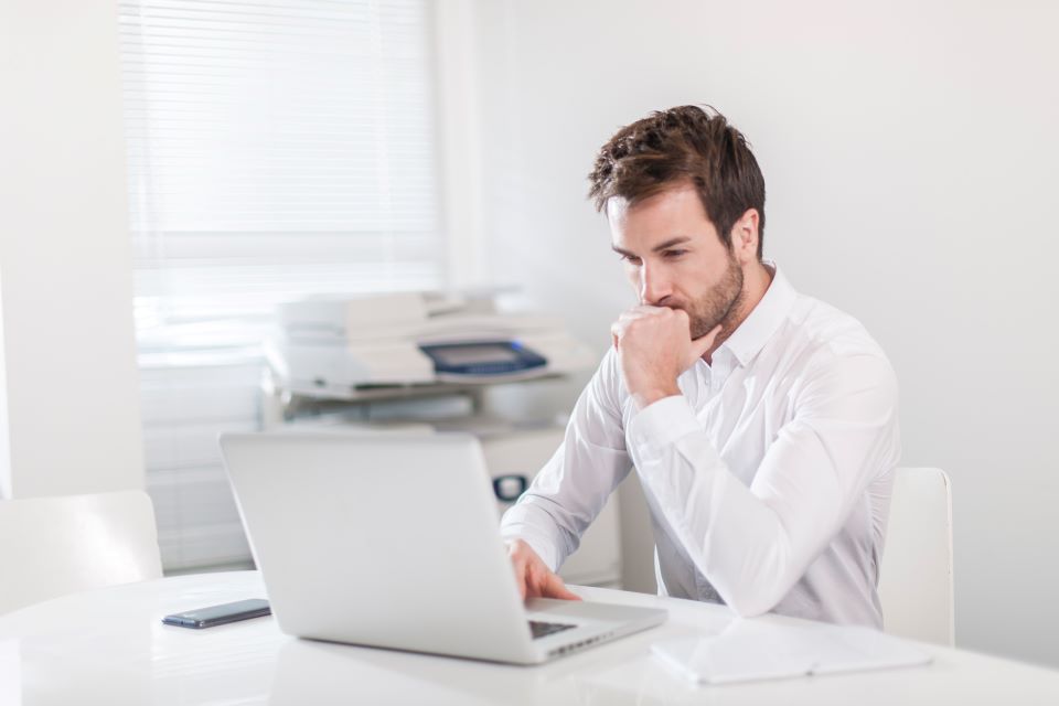 Woman at equipment dealership trying to choose the right dealership management system